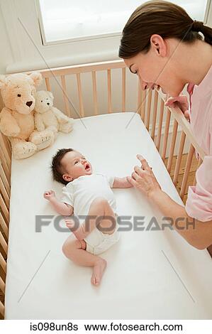 Mother with baby in crib View Large Photo Image Stock Photograph - Mother with baby in crib. Fotosearch