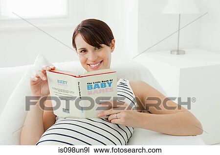 Pregnant woman with baby name book View Large Photo Image Stock Image - Pregnant woman with baby name book. Fotosearch