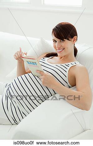 Pregnant woman with baby name book View Large Photo Image Stock Image - Pregnant woman with baby name book. Fotosearch