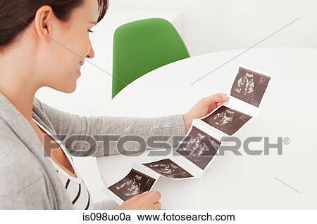 Pregnant woman with baby scan View Large Photo Image Stock Image - Pregnant woman with baby scan. Fotosearch