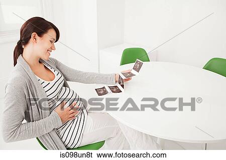 Pregnant woman with baby scan View Large Photo Image Stock Photograph - Pregnant woman with baby scan. Fotosearch