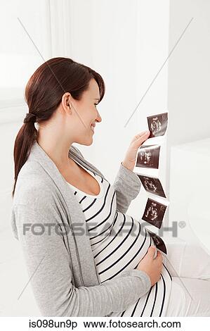 Pregnant woman with baby scan View Large Photo Image Stock Photography - Pregnant woman with baby scan. Fotosearch
