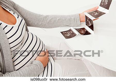 Pregnant woman with baby scan View Large Photo Image Stock Photography - Pregnant woman with baby scan. Fotosearch
