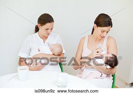 Two mothers with their babies View Large Photo Image Stock Photo - Two mothers with their babies. Fotosearch