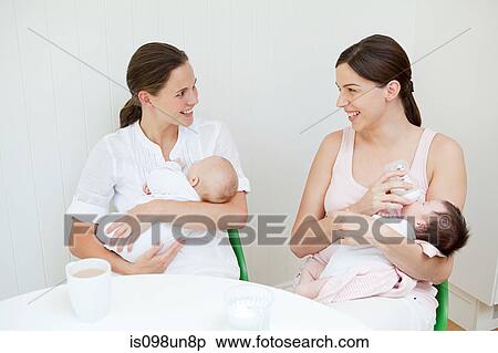 Two mothers with their babies View Large Photo Image Stock Photography - Two mothers with their babies. Fotosearch