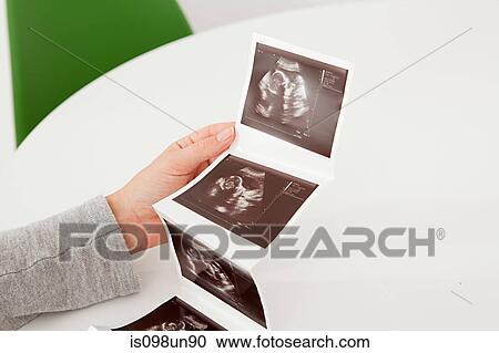 Woman holding baby scan View Large Photo Image Stock Image - Woman holding baby scan. Fotosearch