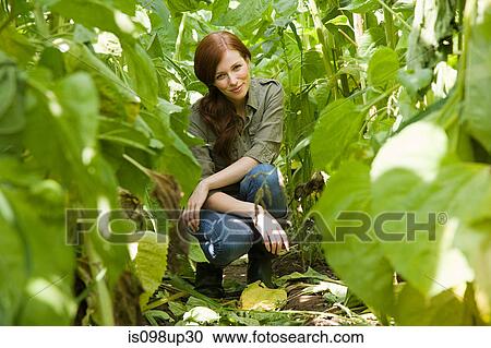 Young woman in field View Large Photo Image Stock Image - Young woman in field. Fotosearch