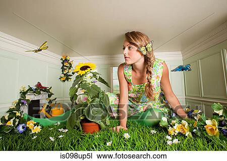 Young woman with garden in small room View Large Photo Image Stock Image - Young woman with garden in small room. Fotosearch