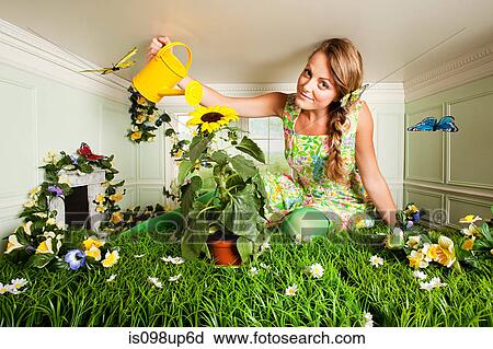 Young woman with garden in small room View Large Photo Image Stock Image - Young woman with garden in small room. Fotosearch