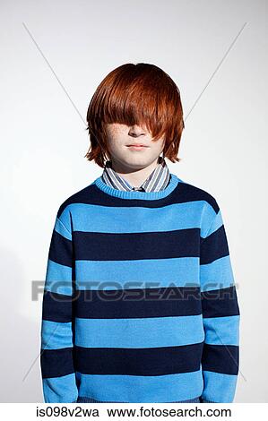 Stock Image - Boy in striped sweater with hair covering his eyes. Fotosearch