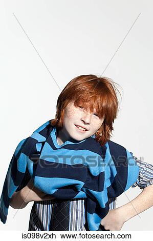 Stock Image - Boy taking off his sweater. Fotosearch