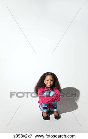Girl hugging her knees View Large Photo Image Stock Photo - Girl hugging her knees. Fotosearch