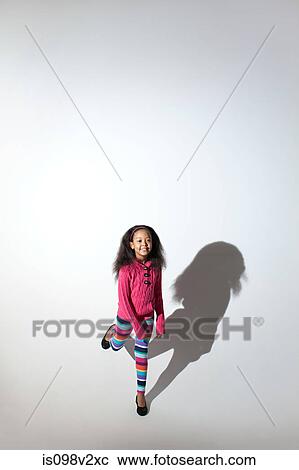 Girl standing on one leg with shadow View Large Photo Image Stock Image - Girl standing on one leg with shadow. Fotosearch