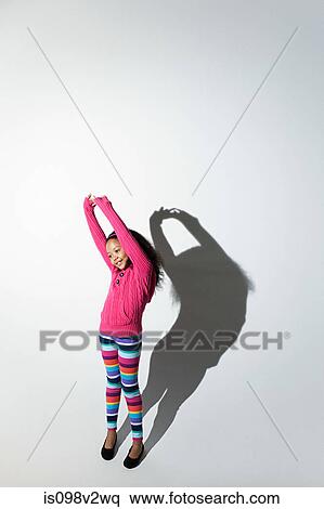 Girl with arms raised and shadow View Large Photo Image Stock Photography - Girl with arms raised and shadow. Fotosearch