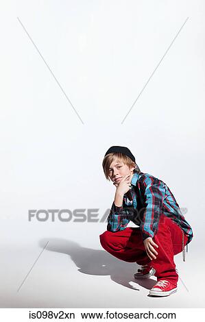 Teenage boy crouching View Large Photo Image Picture - Teenage boy crouching. Fotosearch