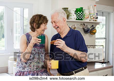 Picture - Senior couple having hot drink. Fotosearch