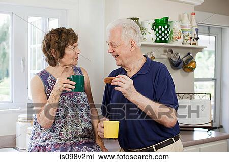 Stock Image - Senior couple having hot drink. Fotosearch