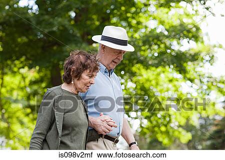 Stock Image - Senior couple holding hands. Fotosearch
