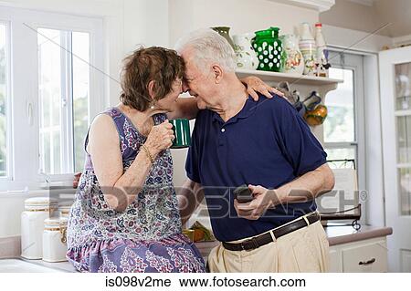Stock Image - Senior couple in kitchen. Fotosearch