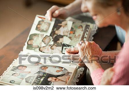 Senior couple looking at family album View Large Photo Image Stock Image - Senior couple looking at family album. Fotosearch