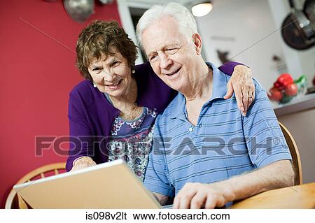 Senior couple using laptop View Large Photo Image Stock Photograph - Senior couple using laptop. Fotosearch