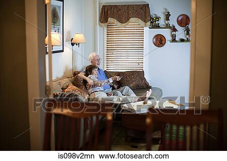Senior couple watching tv at home View Large Photo Image Picture - Senior couple watching tv at home. Fotosearch