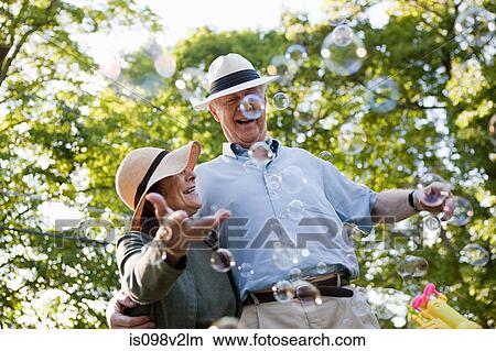 Senior couple with bubbles View Large Photo Image Picture - Senior couple with bubbles. Fotosearch
