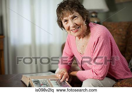 Senior woman with family album View Large Photo Image Stock Photography - Senior woman with family album. Fotosearch