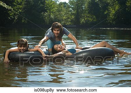 Couple and daughter having fun in lake View Large Photo Image Stock Photo - Couple and daughter having fun in lake. Fotosearch
