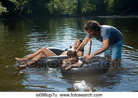Couple and daughter having fun in lake View Large Photo Image Stock Photograph - Couple and daughter having fun in lake. Fotosearch