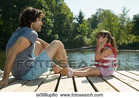 Father and daughter on jetty in lake View Large Photo Image Picture - Father and daughter on jetty in lake. Fotosearch