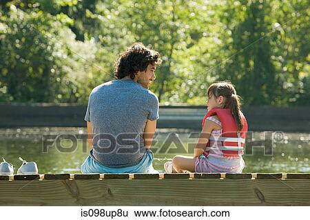 Father and daughter on jetty in lake View Large Photo Image Stock Photograph - Father and daughter on jetty in lake. Fotosearch