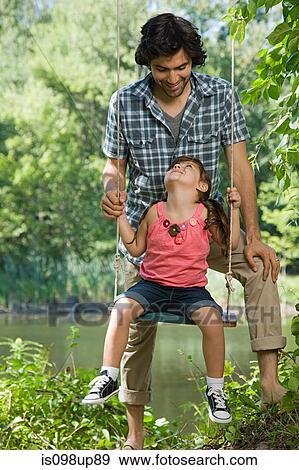 Father and daughter on swing View Large Photo Image Stock Photo - Father and daughter on swing. Fotosearch