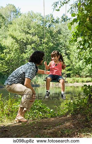 Father and daughter on swing View Large Photo Image Stock Photo - Father and daughter on swing. Fotosearch
