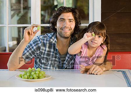 Father and daughter with grapes View Large Photo Image Stock Image - Father and daughter with grapes. Fotosearch