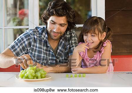 Father and daughter with grapes View Large Photo Image Stock Photo - Father and daughter with grapes. Fotosearch