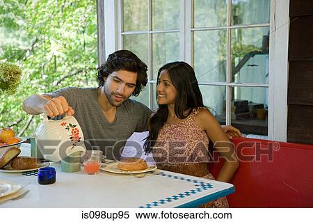 Man pouring juice for woman View Large Photo Image Stock Photography - Man pouring juice for woman. Fotosearch