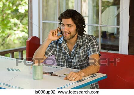Young man on cellphone View Large Photo Image Stock Image - Young man on cellphone. Fotosearch