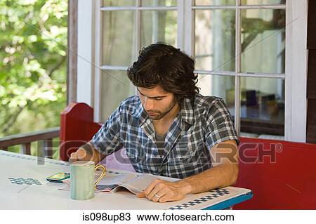 Young man reading magazine View Large Photo Image Stock Image - Young man reading magazine. Fotosearch