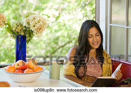 Picture - Young woman reading a book. Fotosearch