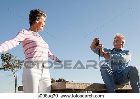 Man photographing woman View Large Photo Image Stock Image - Man photographing woman. Fotosearch