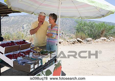 Mature couple at rural fruit stand View Large Photo Image Stock Photo - Mature couple at rural fruit stand. Fotosearch