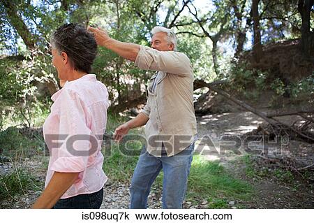 Stock Image - Mature couple dancing in forest. Fotosearch