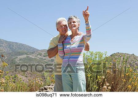 Stock Image - Mature couple in rural setting. Fotosearch