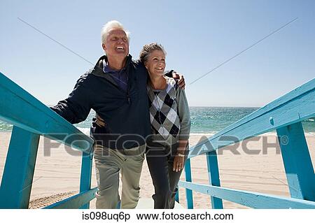Mature couple on beach walkway View Large Photo Image Stock Photography - Mature couple on beach walkway. Fotosearch