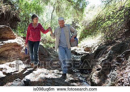 Mature couple walking in forest View Large Photo Image Picture - Mature couple walking in forest. Fotosearch