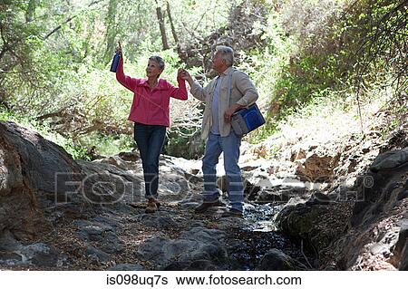 Mature couple walking in forest View Large Photo Image Stock Photograph - Mature couple walking in forest. Fotosearch