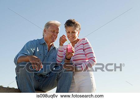 Mature couple with bubbles View Large Photo Image Stock Photo - Mature couple with bubbles. Fotosearch