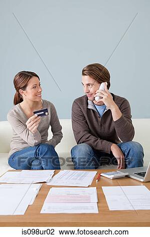 Young couple doing paperwork View Large Photo Image Stock Image - Young couple doing paperwork. Fotosearch