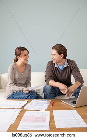 Young couple doing paperwork View Large Photo Image Stock Photography - Young couple doing paperwork. Fotosearch